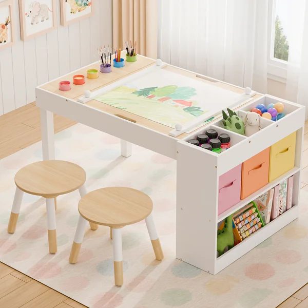 Children's art studio table with paper roll, paint cups, crayons and pastel storage bins