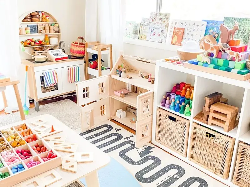 Playroom with a small selection of toys displayed on low shelves for toy rotation